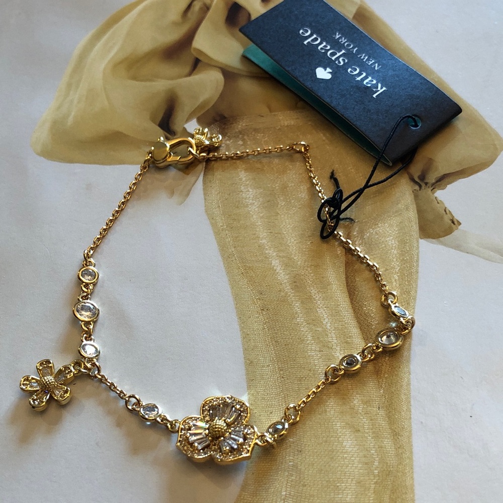 Authentic New with tag Kate spade crystal flower gold tone bracelet.